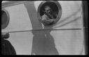 Image of Man leaning out of porthole
